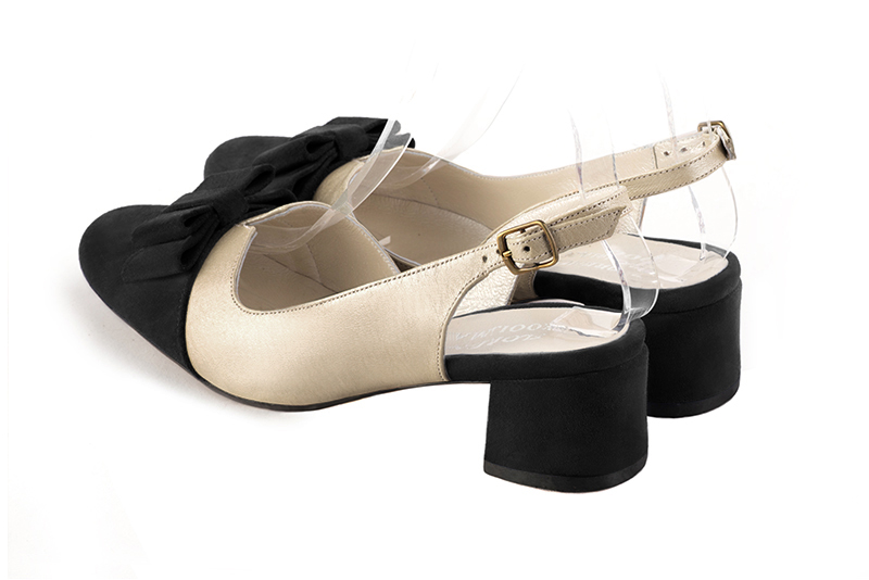 Matt black and gold women's open back shoes, with a knot. Round toe. Low flare heels. Rear view - Florence KOOIJMAN